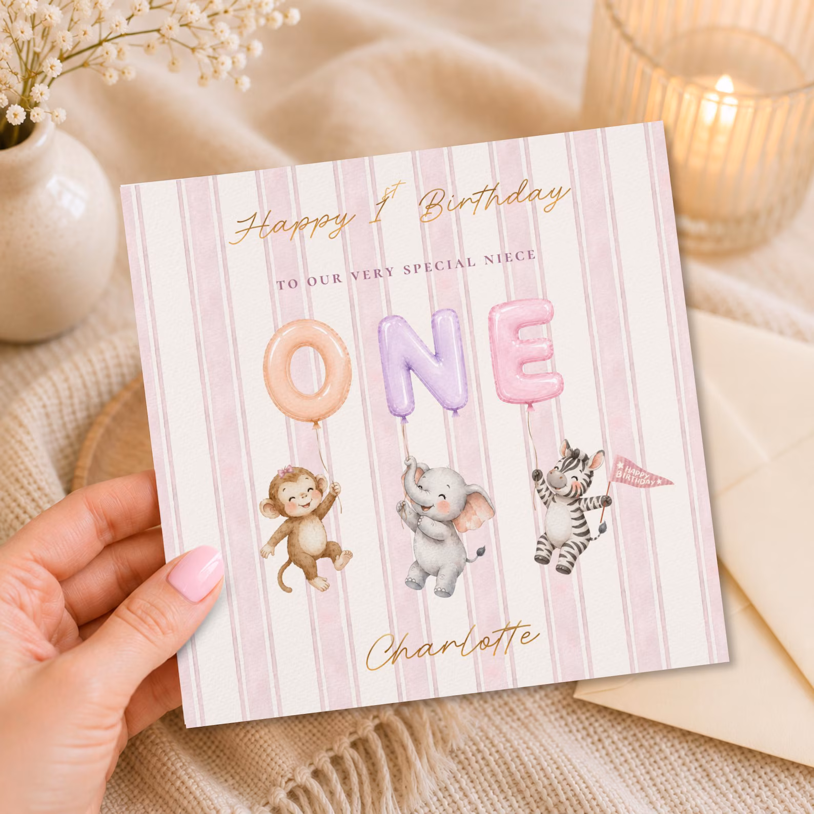 A personalised pink stripe safari birthday card with foiled balloon letters